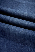 Close-up of blue denim fabric with a textured pattern