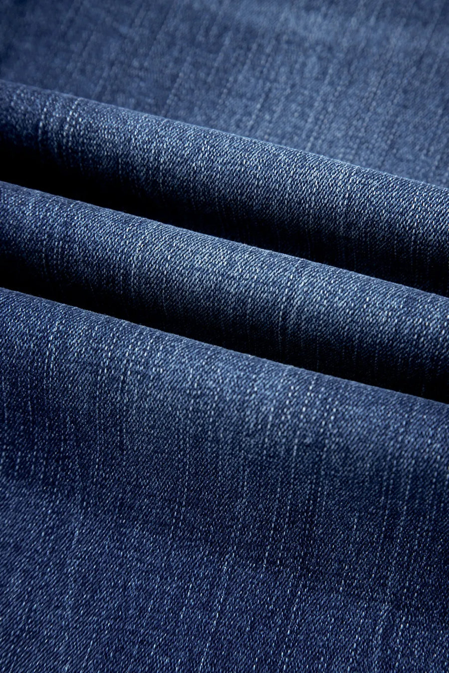 Close-up of blue denim fabric with a textured pattern