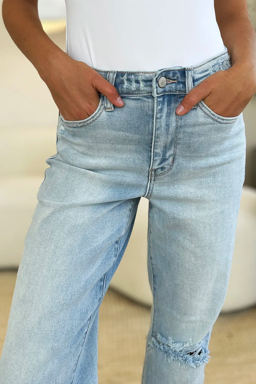 Light blue jeans worn by a person with a blurred background
