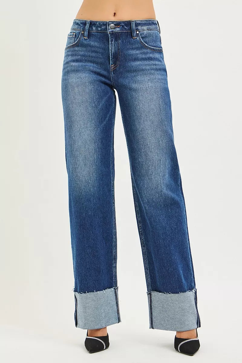 Blue jeans with a cuffed hem on a white background