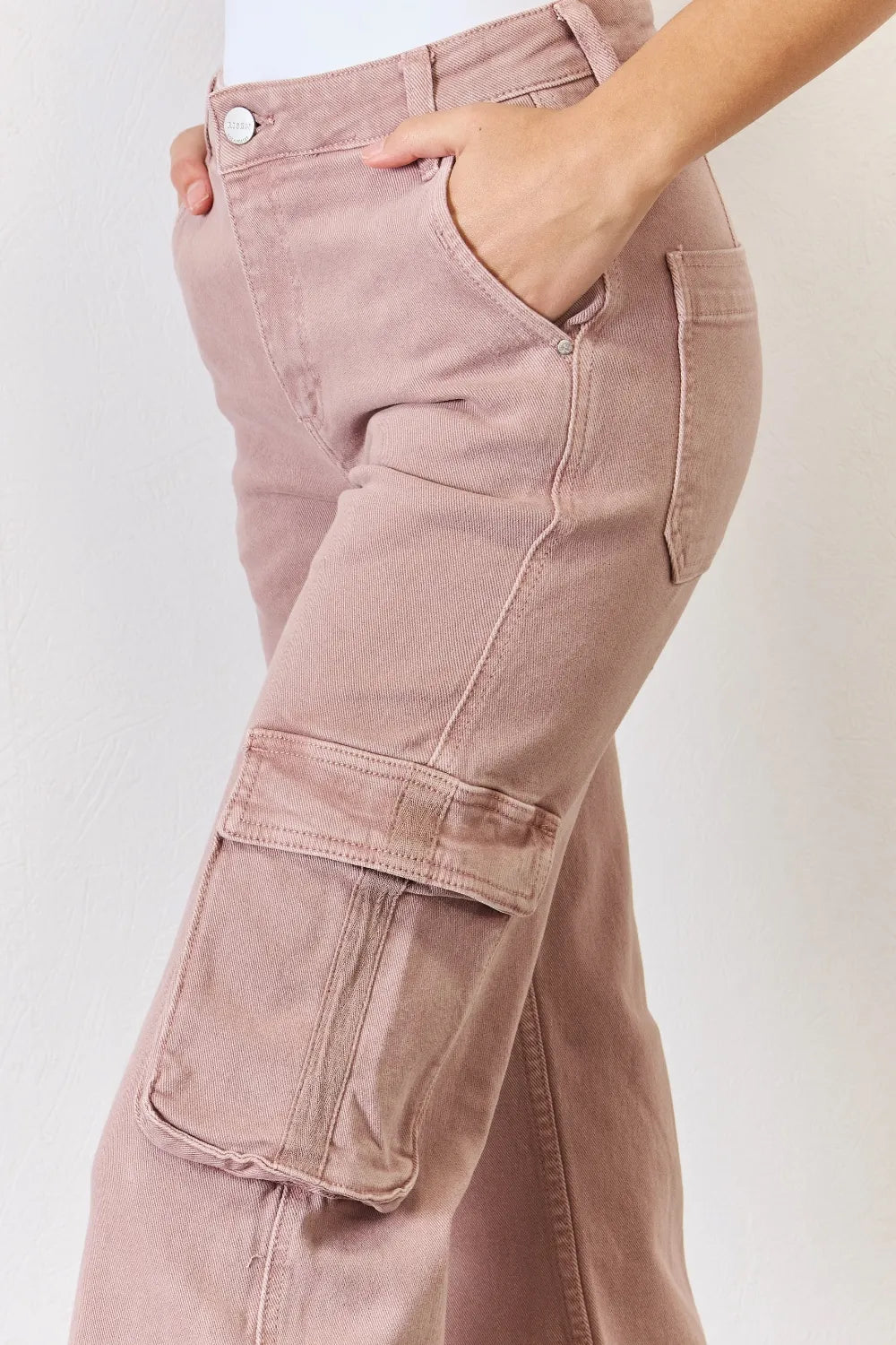 Pink cargo pants with a plain background