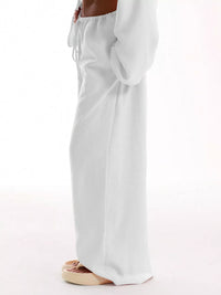 White wide-leg pants worn by a person on a white background