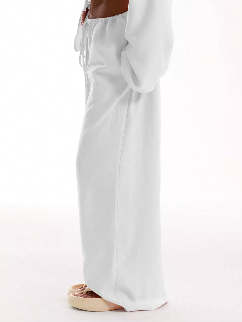 White wide-leg pants worn by a person on a white background