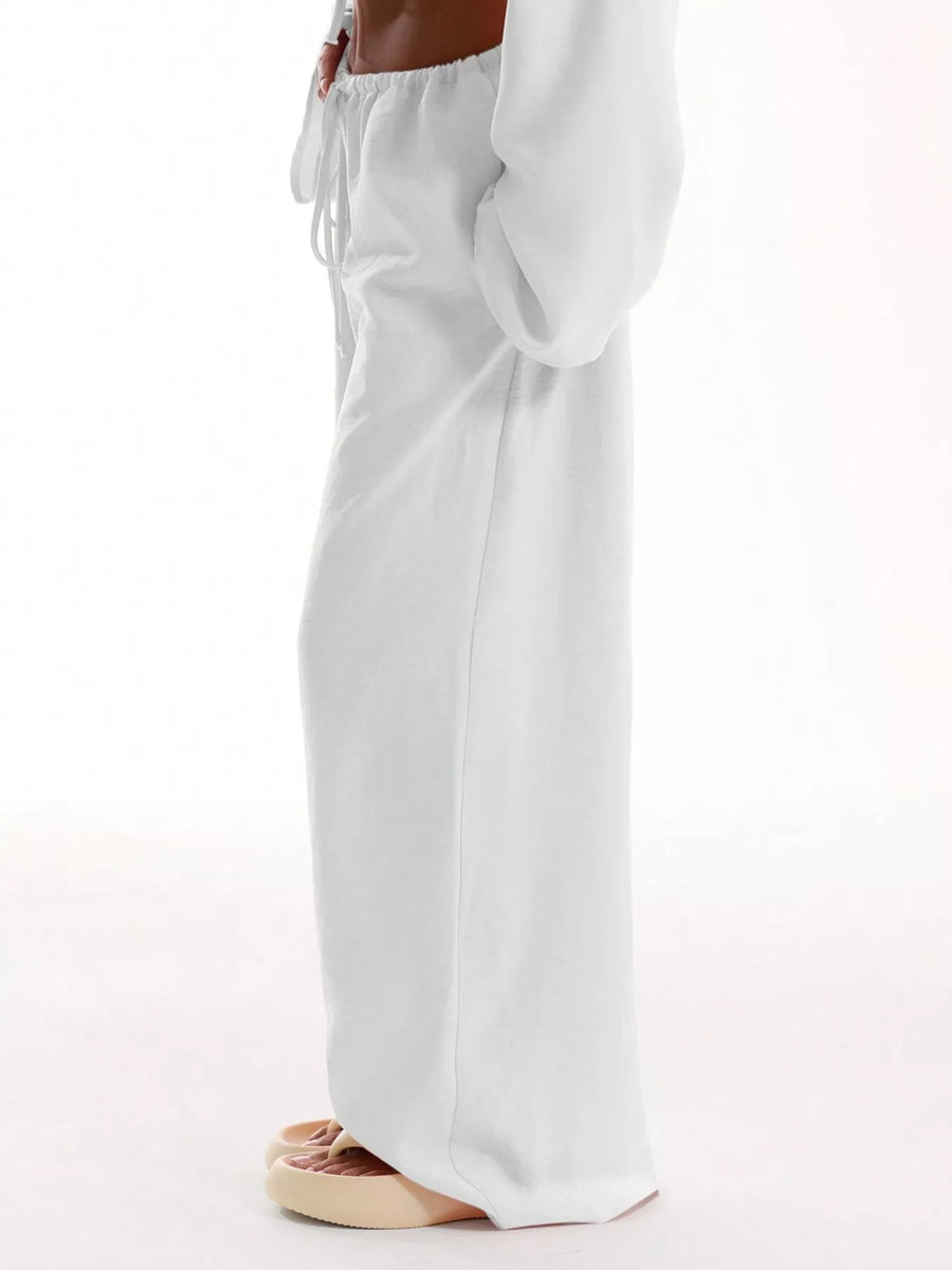 White wide-leg pants worn by a person on a white background