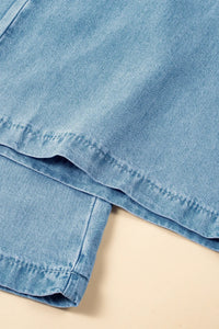 Close-up of a folded denim skirt on a beige surface