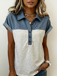 Woman wearing a two-tone shirt with denim and beige sections on a plain background
