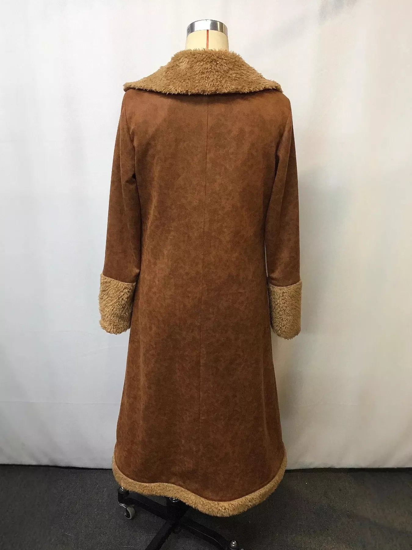 Brown coat with fur trim on a mannequin against a white background
