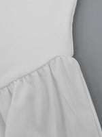 Light gray dress with a plain background