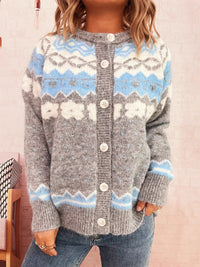 Person wearing a gray sweater with blue and white pattern