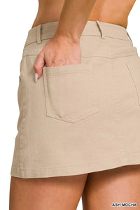Beige skirt worn by a person on a white background