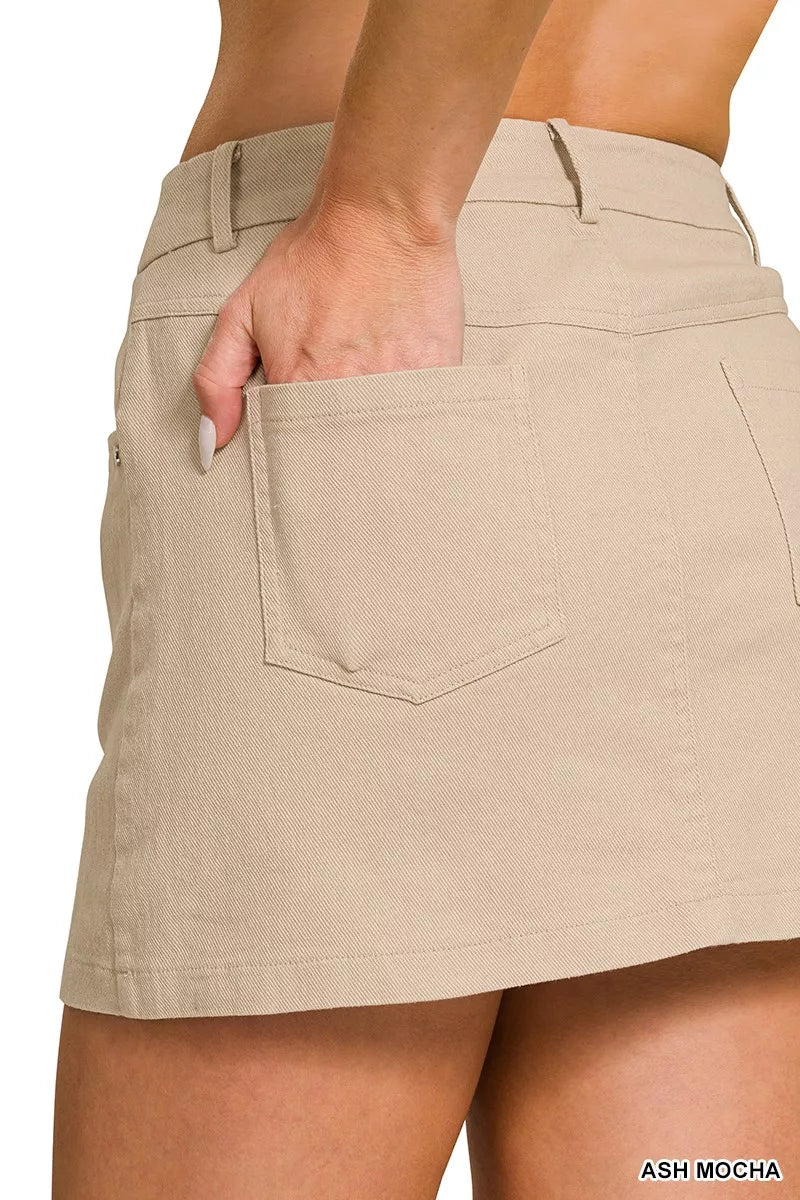 Beige skirt worn by a person on a white background