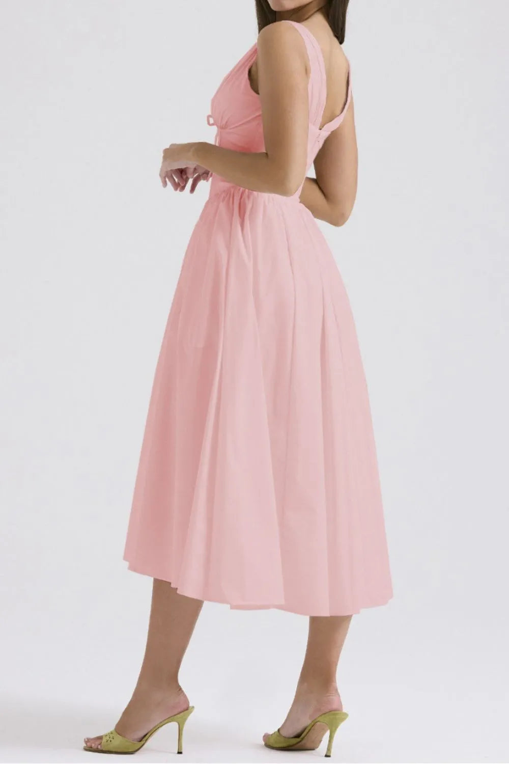 Woman wearing a pink dress on a white background