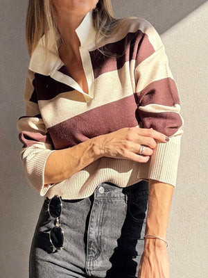 Person wearing a patterned sweater with a neutral background
