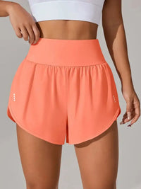 Coral shorts worn by a person on a plain background