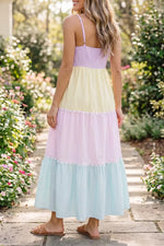Woman wearing a colorful striped dress in a garden setting