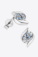 Silver earrings with clear gemstones on a white background