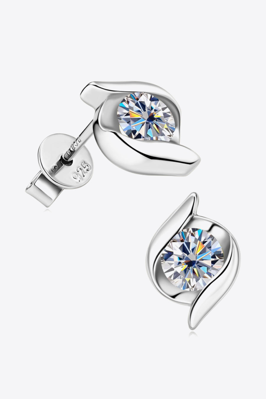 Silver earrings with clear gemstones on a white background