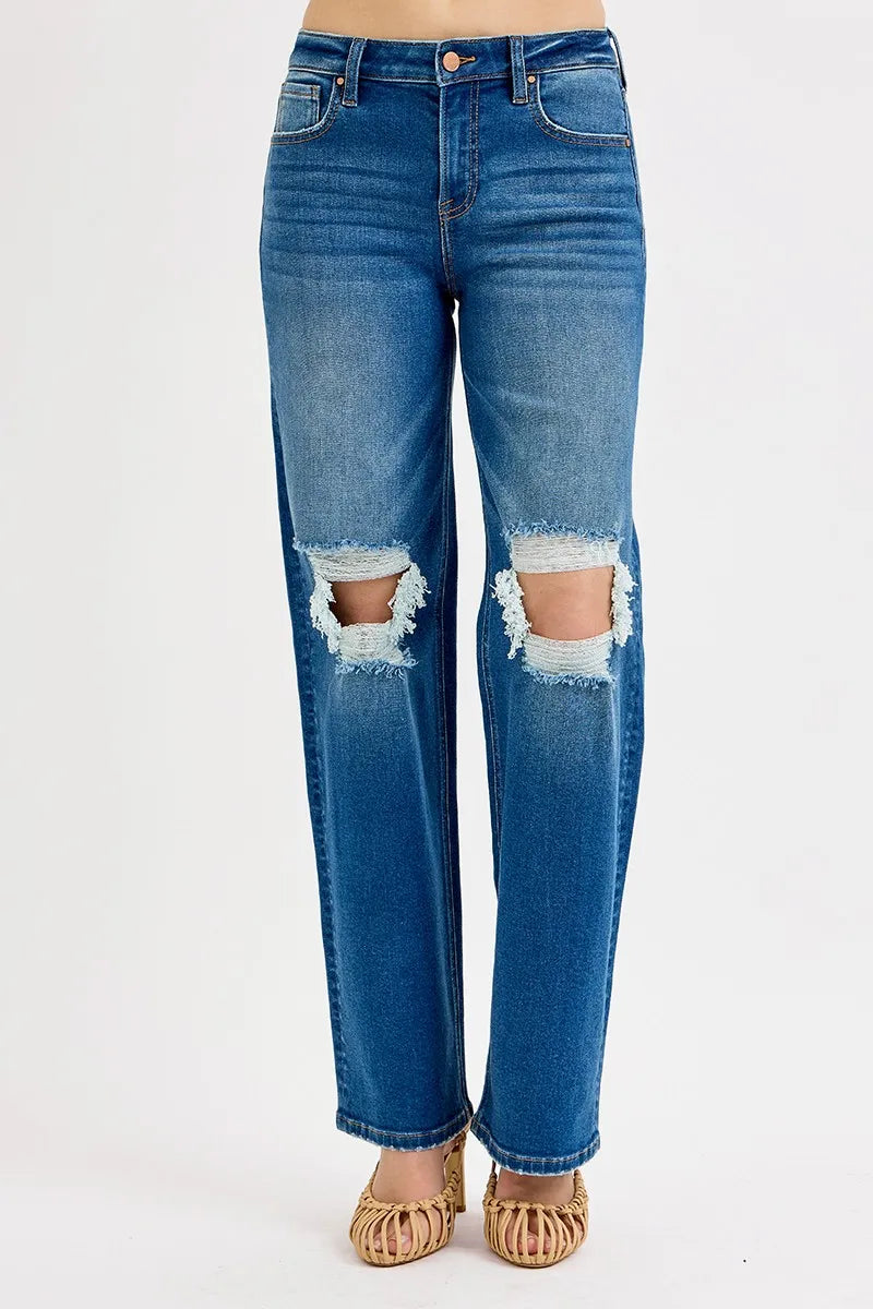 Blue jeans with distressing on a white background