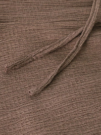 Close-up of a brown fabric texture with a single thread