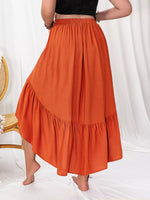 Person wearing an orange skirt with a white background