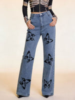 Blue jeans with black butterfly designs on a beige background