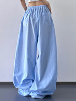 Blue striped wide-leg pants worn by a person against a plain background
