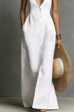 Person wearing a white dress holding a straw hat against a neutral background