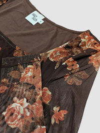 Floral-patterned garment with a visible brand tag on a plain background