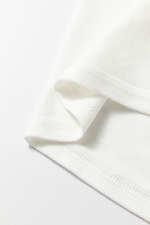 Close up view of hem on Number 76 Round Neck Long Sleeve Top