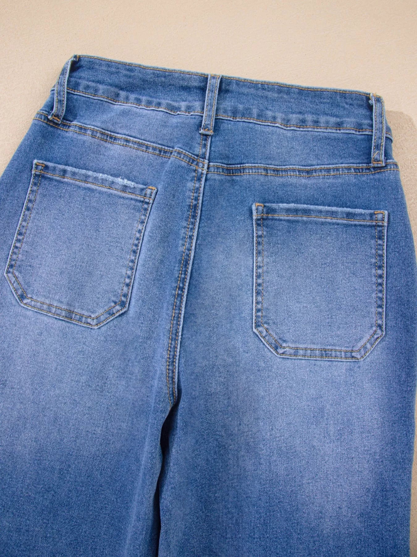 Blue jeans with a beige background