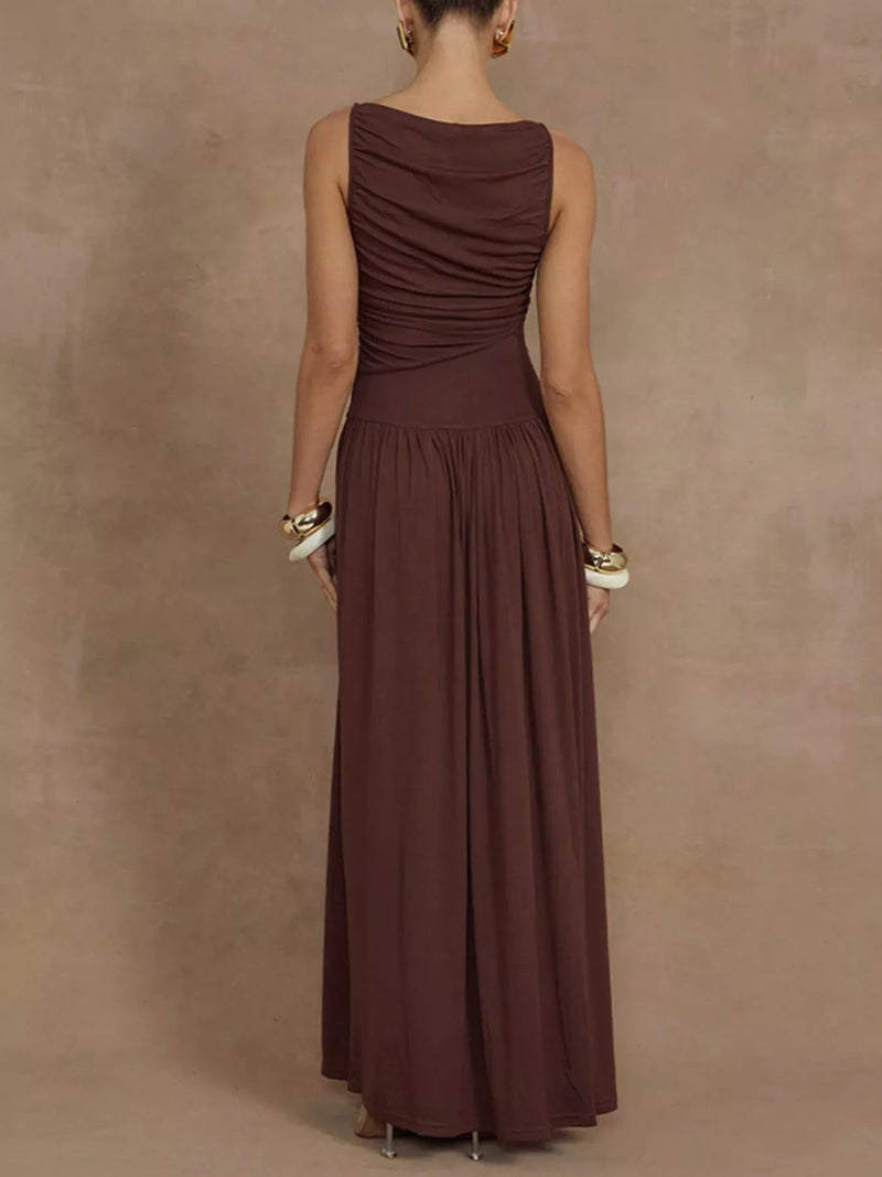 Woman wearing a brown dress against a beige background