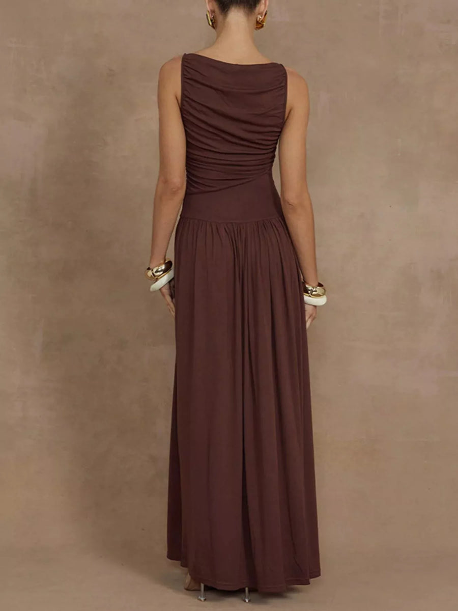 Woman wearing a brown dress against a beige background