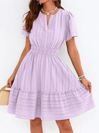Woman wearing a light purple dress on a white background