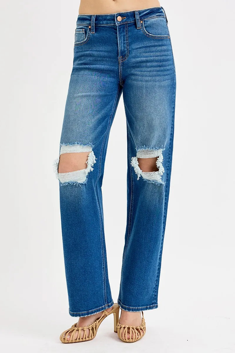 Blue jeans with distressing on a white background
