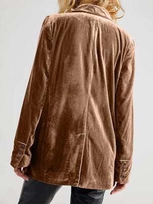 Brown jacket worn by a person on a plain background