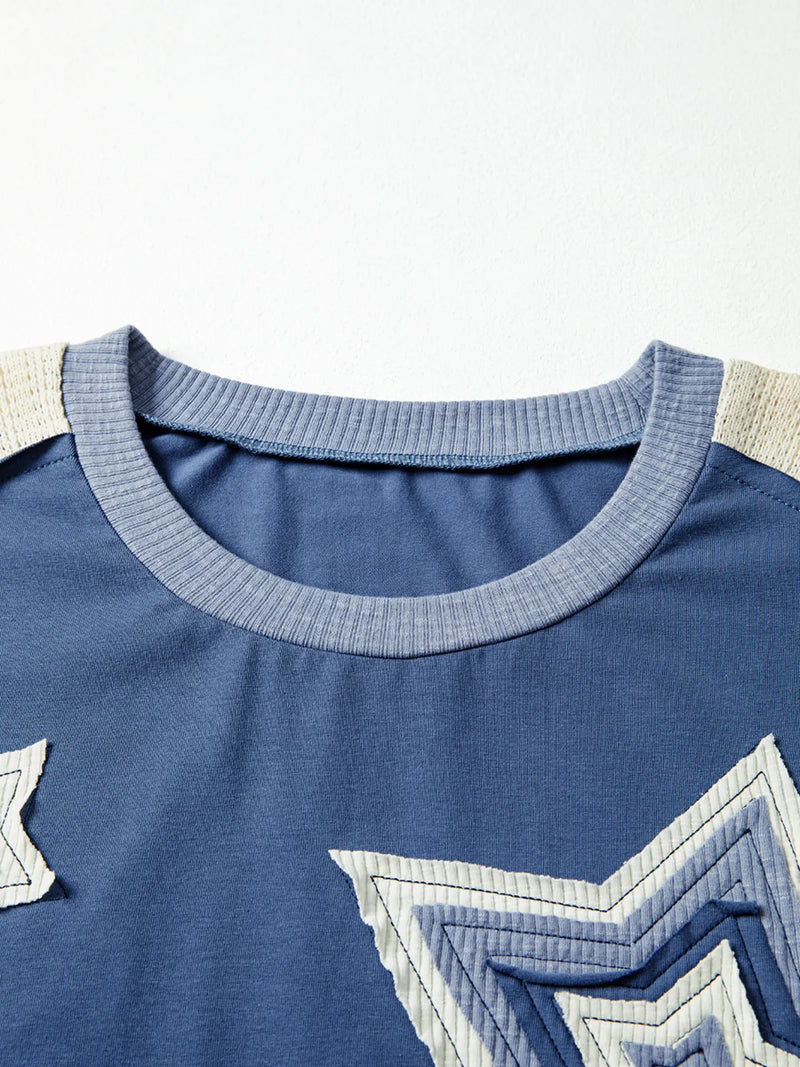 Close-up of a blue shirt with star designs on a white background