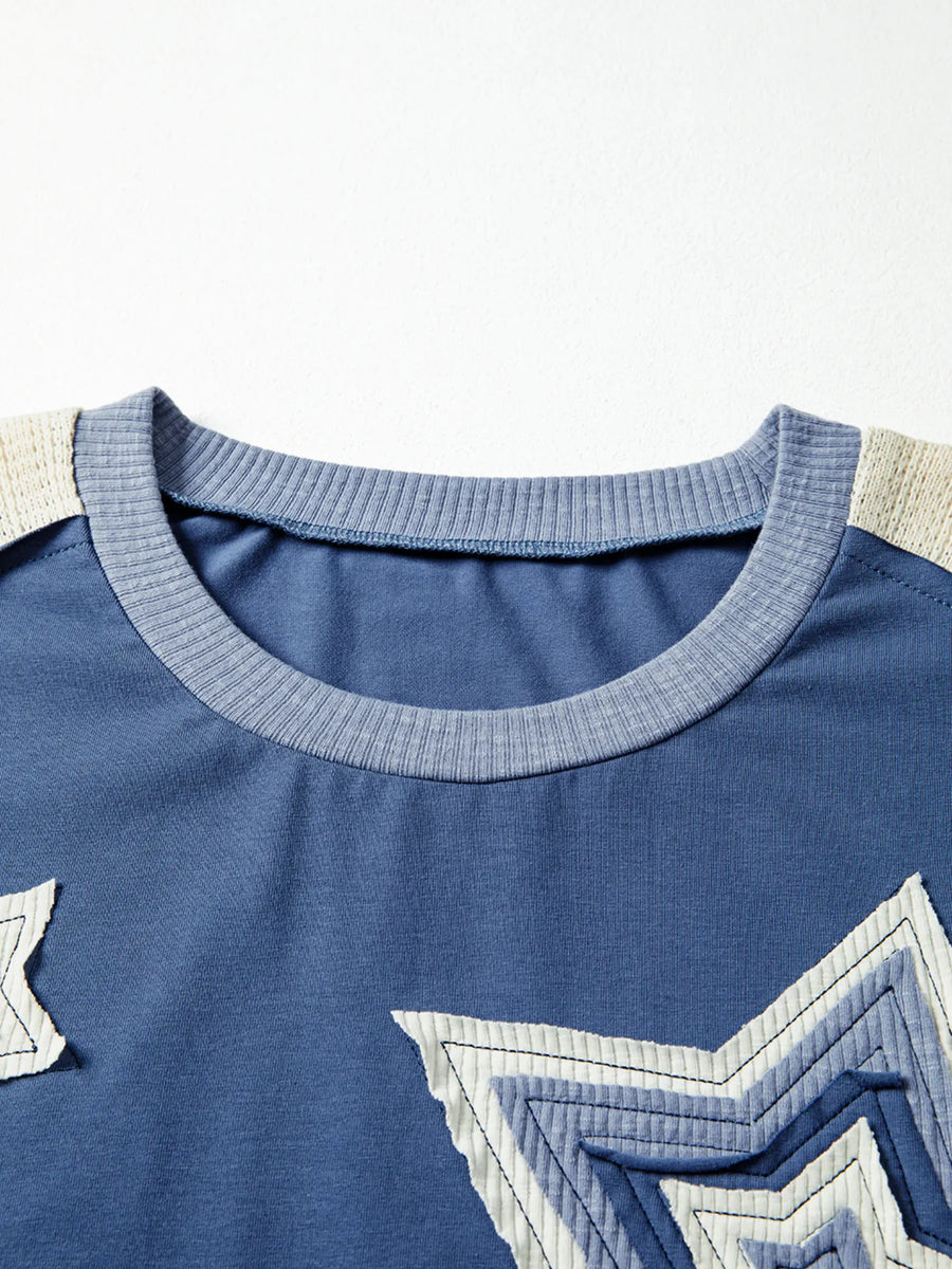 Close-up of a blue shirt with star designs on a white background