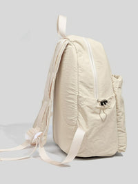 Beige backpack on a light gray background