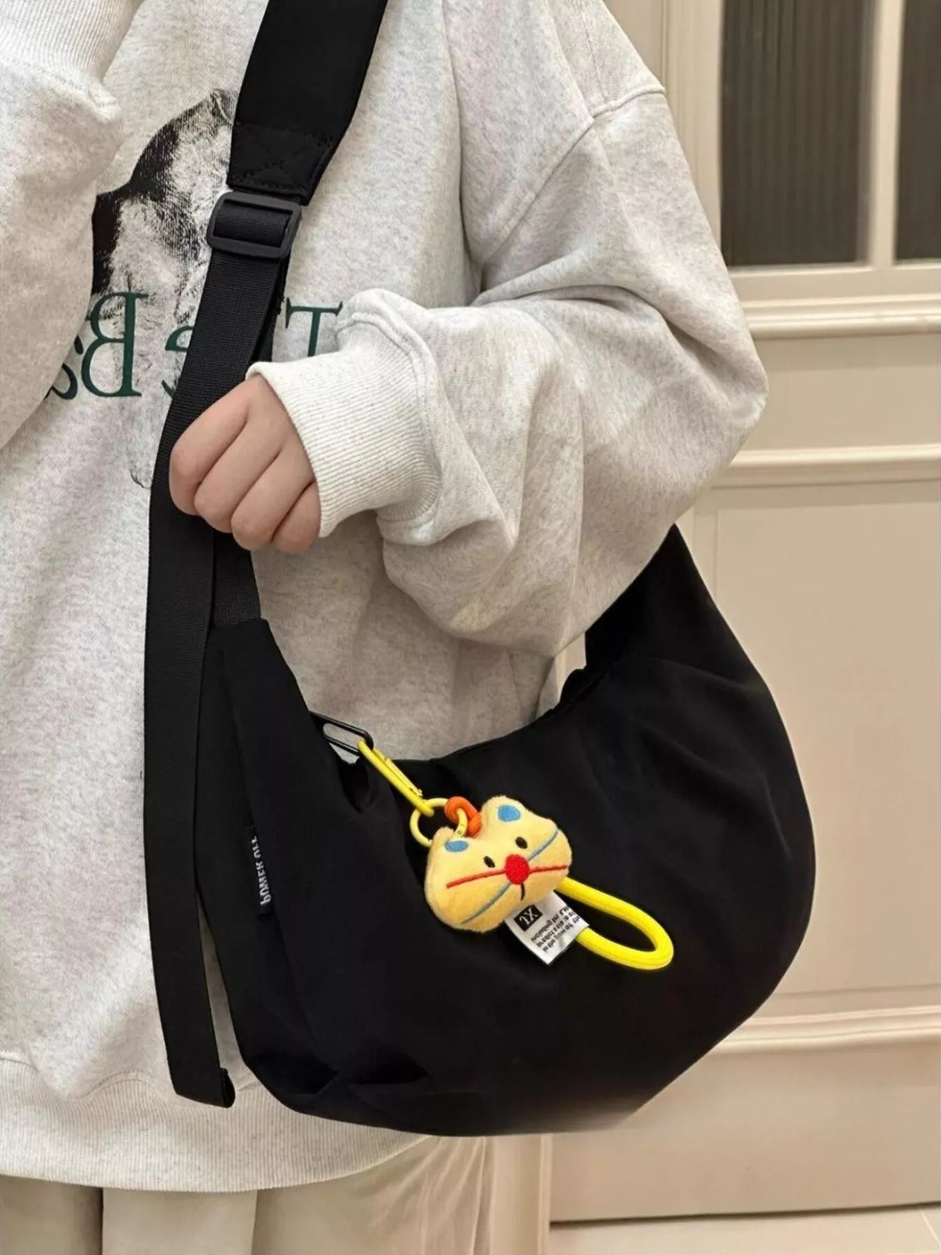 A young woman carrying a black Adjustable Strap Crossbody Bag Purse