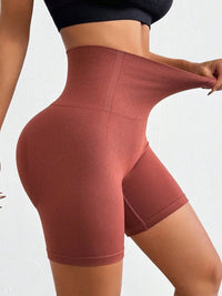 Brown high-waisted leggings being modeled on a white background