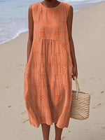 Person wearing an orange dress with a beach background