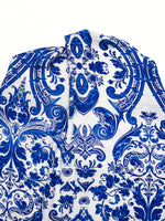 Blue and white patterned fabric with intricate designs on a white background
