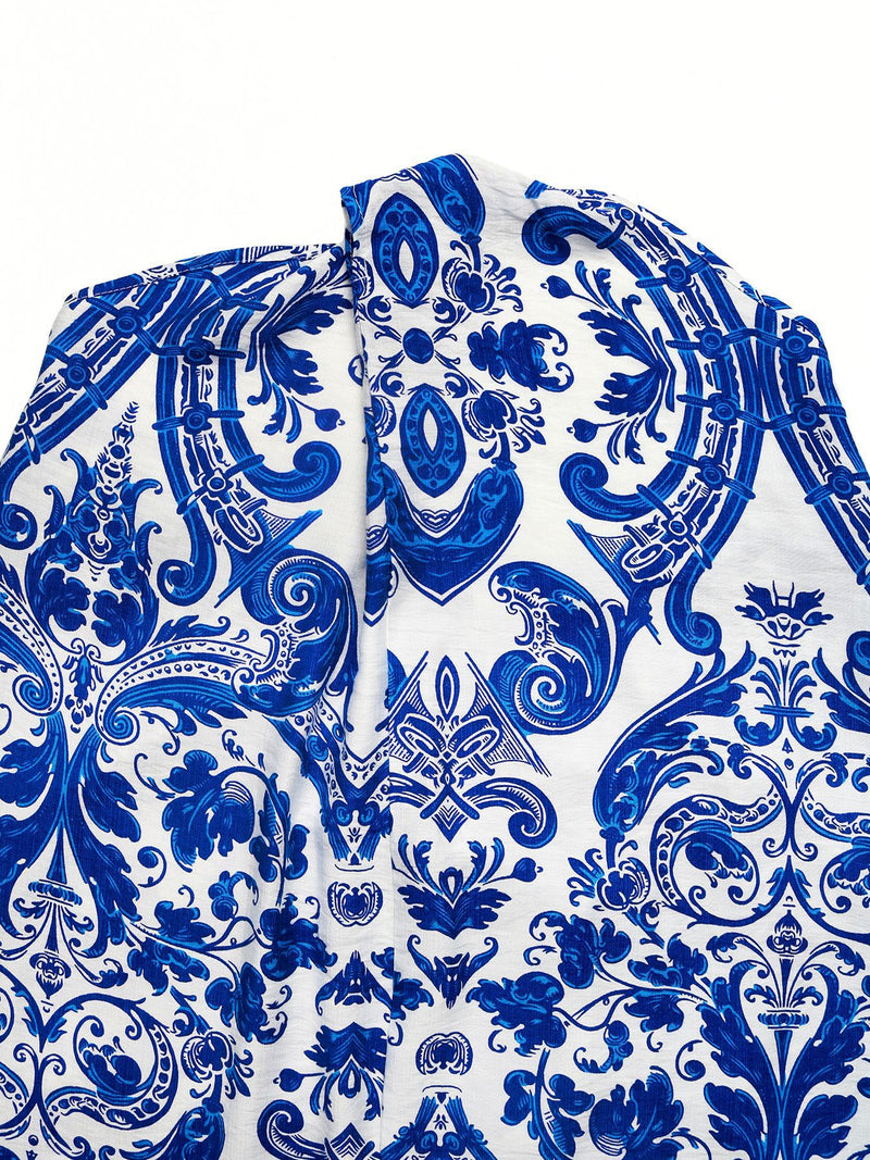 Blue and white patterned fabric with intricate designs on a white background