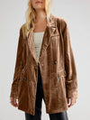 Brown corduroy coat worn by a person on a plain background