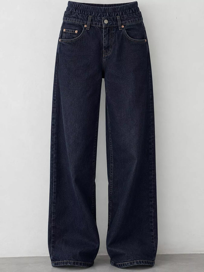 Dark navy blue wide-leg denim jeans with an elastic waistband, displayed against a plain light gray wall.
