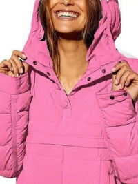 Person wearing a pink puffer jacket with a white background