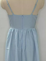Light blue dress on a mannequin against a plain background