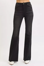 Black flared jeans on a white background