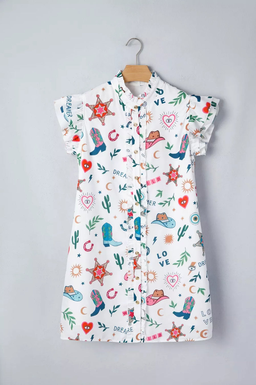 Children's dress with colorful patterns on a hanger against a gray background