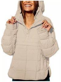 Beige puffer jacket worn by a person on a white background